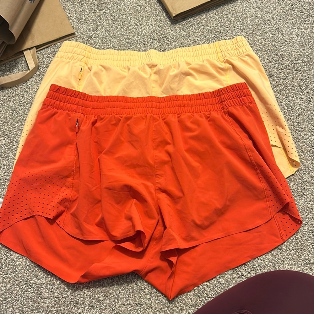 Bundle of TWO orange athleta hustle shorts 3”